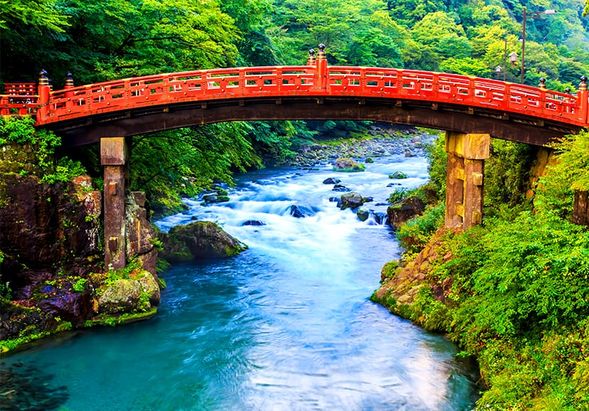 The wooden, vermilion-lacquered Shinkyo Bridge marks the entrance to the Nikko mountains. Legend has it that Shodo Shonin could not cross the Daiya River at this location, so he prayed for divine intervention, and two snakes appeared, transforming into the bridge.