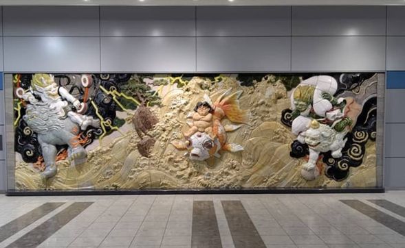 The guide will be waiting for you in front of the mural artwork next to the International Arrivals Exit on the 1st floor of Sendai Airport, holding a blue board that reads 'HIS'.