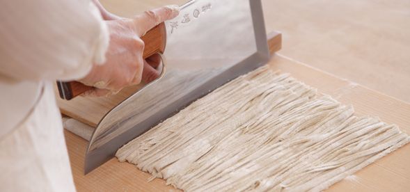 そば粉をこね、生地を伸ばして、細く均一に切りそろえます