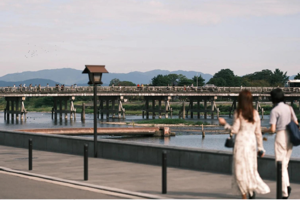 【渡月桥】建于 9 世纪前叶的平安时代,曾多次遭洪水冲毁后重新建造。渡月桥的名字由来据说是因镰仓时代的龟山天皇乘船赏月时,咏叹月亮看起来宛如正在过桥般地移动而得名。渡月桥曾出现在歌川广重和葛饰北斋等人的浮世绘作品中,已成为岚山最具代表性的风景。剧场版动画《名侦探柯南唐红的恋歌》中著名日本歌手仓木麻衣演唱的歌曲《渡月桥思君》也是此地~现在的渡月桥为 1934 年以混凝土建造而成。是可承受车辆通行的桥梁,沿用了传统造桥方式建造,但为融入周围景观,栏杆选用木材制作,是用来拍摄时代剧也毫不突兀的经典取景地点。
渡月桥与春樱、夏绿、秋枫、冬雪与四季更迭的景色完美地融为一体,无论何时造访总有手拿相机的观光客络绎不绝。
【备注】此景点为自由活动,请各位贵宾合理安排景点游玩时间哦~