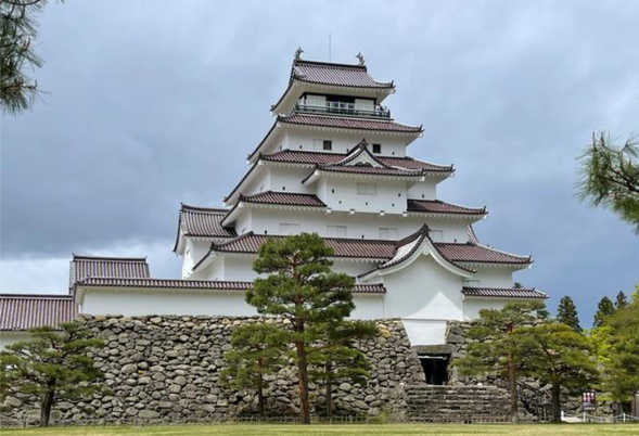 会津若松城,为一座位于日本福岛县会津若松市追手町内的城郭,始建于14世纪,由芦名直盛建造,最初称黑川城。会津若松城亦名“鹤城”(鹤ヶ城),历史文献中亦名为“黑川城”及“会津城”。在日本,一般称之为“会津若松城”,而国家指定的古迹名称为“若松城”。1590年,蒲生氏乡将其改称鹤城并进行扩建,天守曾高达七层。后加藤嘉明将其改建为五层天守。该城是1868年戊辰战争的重要战场,在战争中受损。城堡于1874年被拆除。现在的天守阁于1965年重建 ,最初使用黑瓦,2011年更换为红瓦,重现了江户时代末期的风貌。