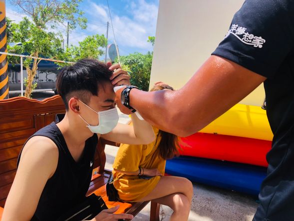 Sanitizing hands and taking temperature